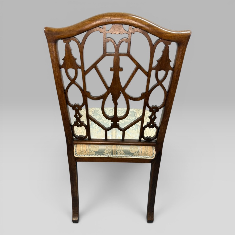 A Georgian Chippendale style dark walnut side chair with carved lattice fretwork on the backrest and a pale blue and gold striped damask seat. View VIII