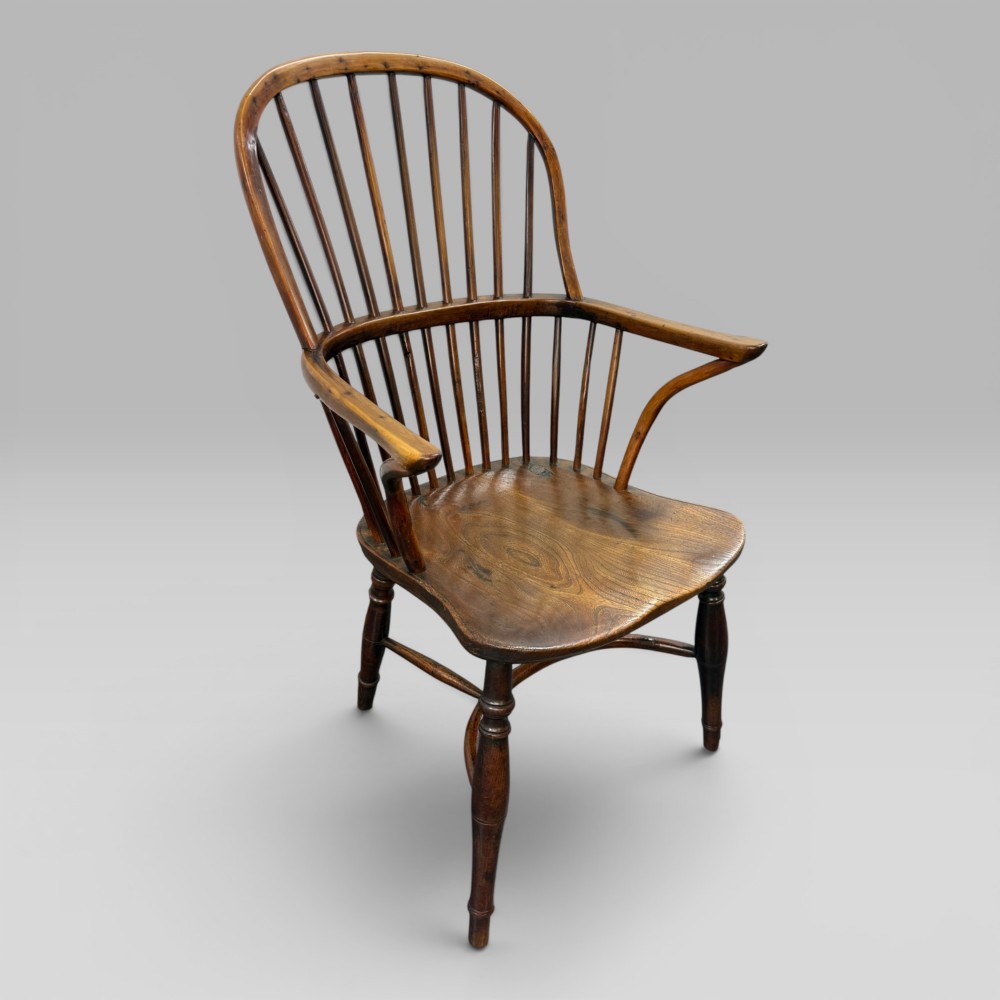 An early nineteenth-century hoop-back Windsor armchair crafted from yew wood and elm with turned legs and a contoured saddle seat. View III