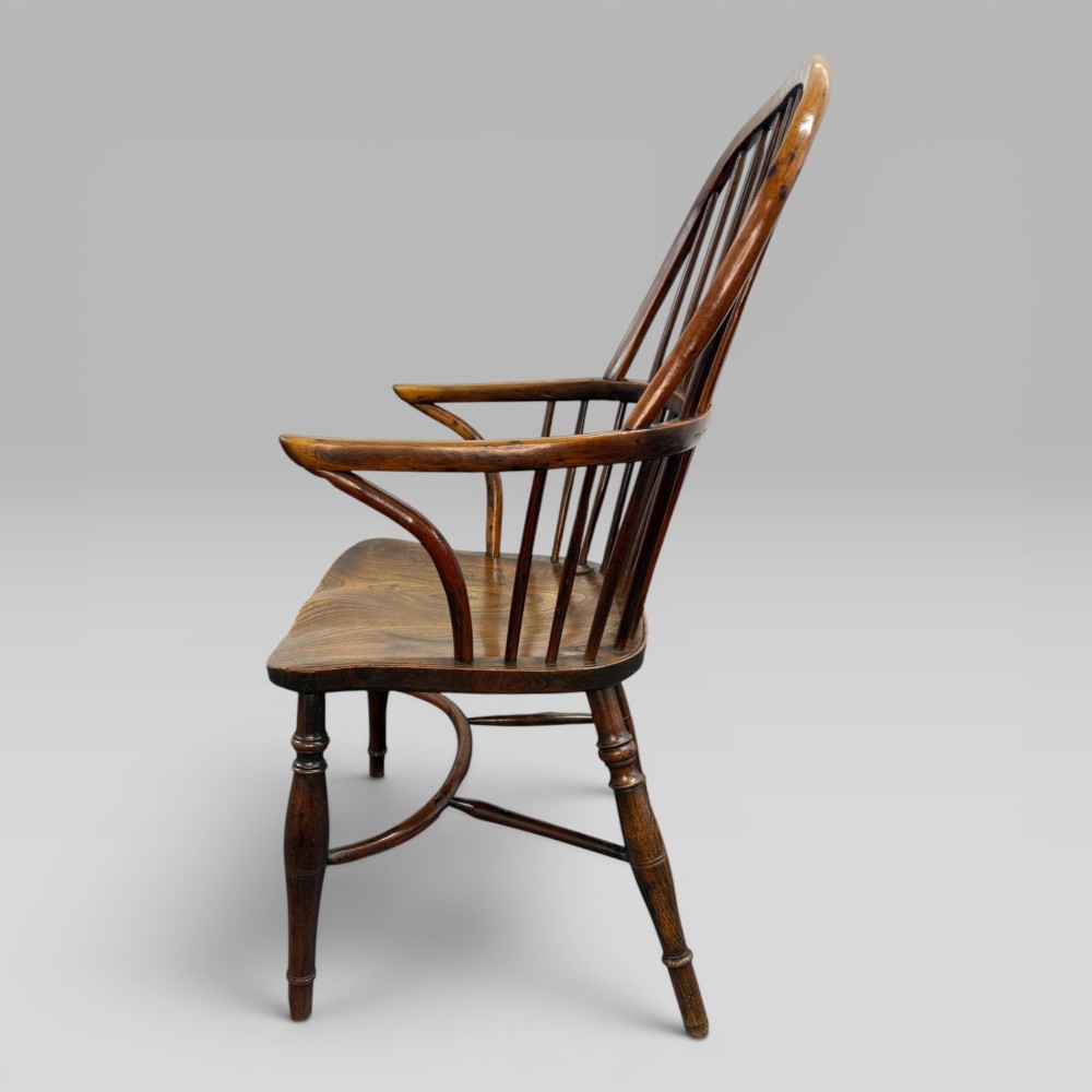 An early nineteenth-century hoop-back Windsor armchair crafted from yew wood and elm with turned legs and a contoured saddle seat. View V