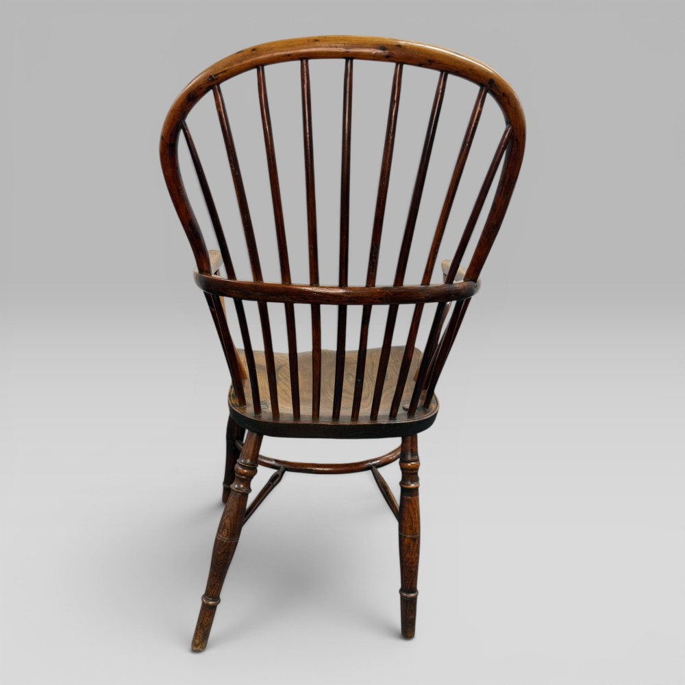 An early nineteenth-century hoop-back Windsor armchair crafted from yew wood and elm with turned legs and a contoured saddle seat. View VI