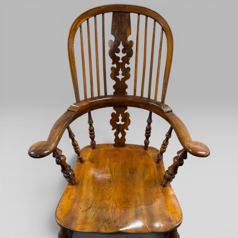 A Victorian high-back Windsor armchair crafted from yew wood and elm with a pierced central splat, spindle back, and turned legs. View IV