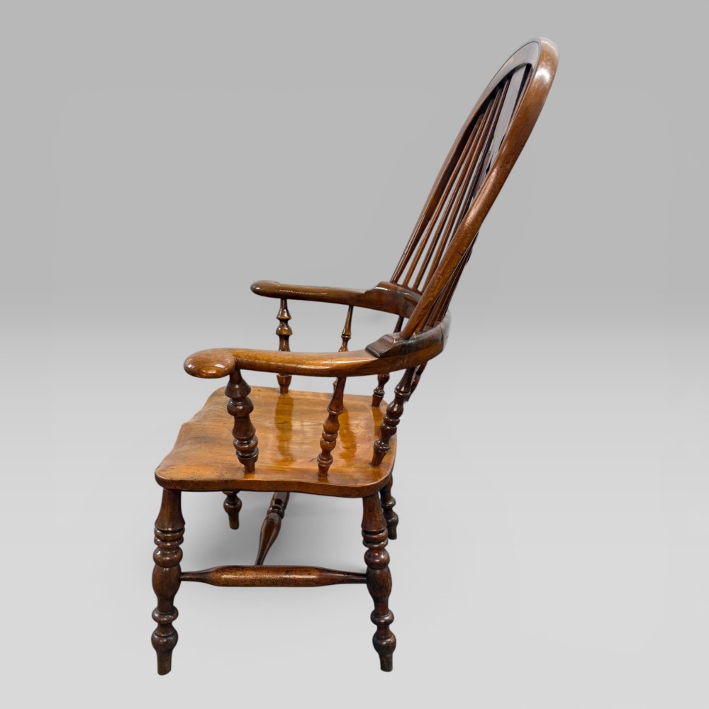 A Victorian high-back Windsor armchair crafted from yew wood and elm with a pierced central splat, spindle back, and turned legs. View V