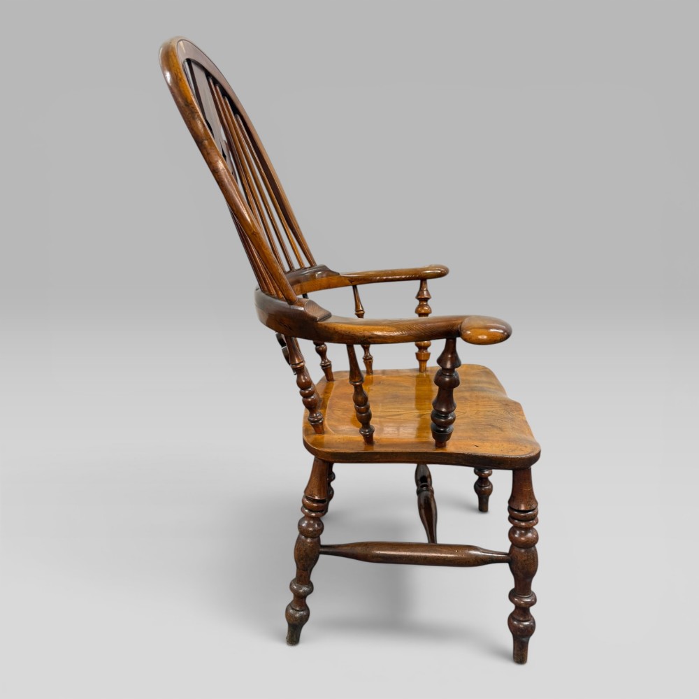 A Victorian high-back Windsor armchair crafted from yew wood and elm with a pierced central splat, spindle back, and turned legs. View VI