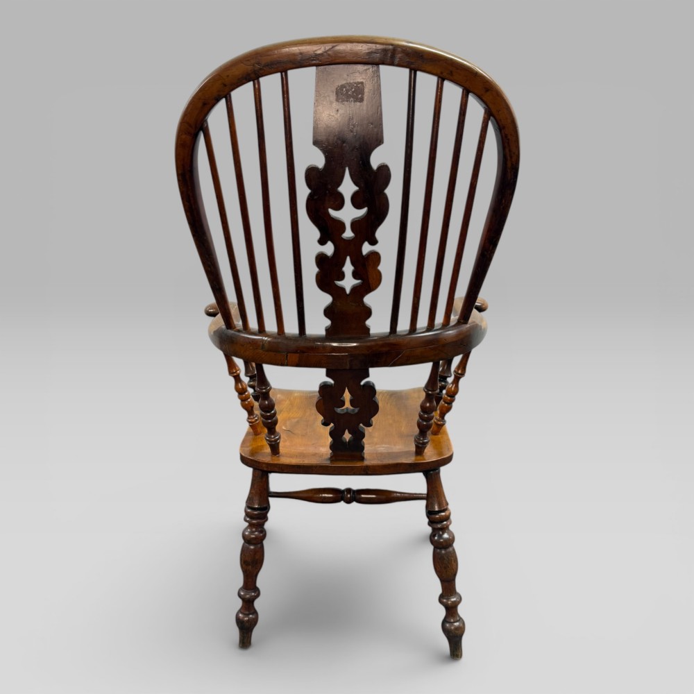 A Victorian high-back Windsor armchair crafted from yew wood and elm with a pierced central splat, spindle back, and turned legs. View VII
