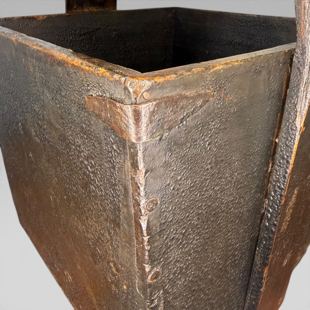 An antique dark brown Chinese elm harvest bucket featuring a tapered square body and a high wooden carrying handle with mortise and tenon joinery. View V