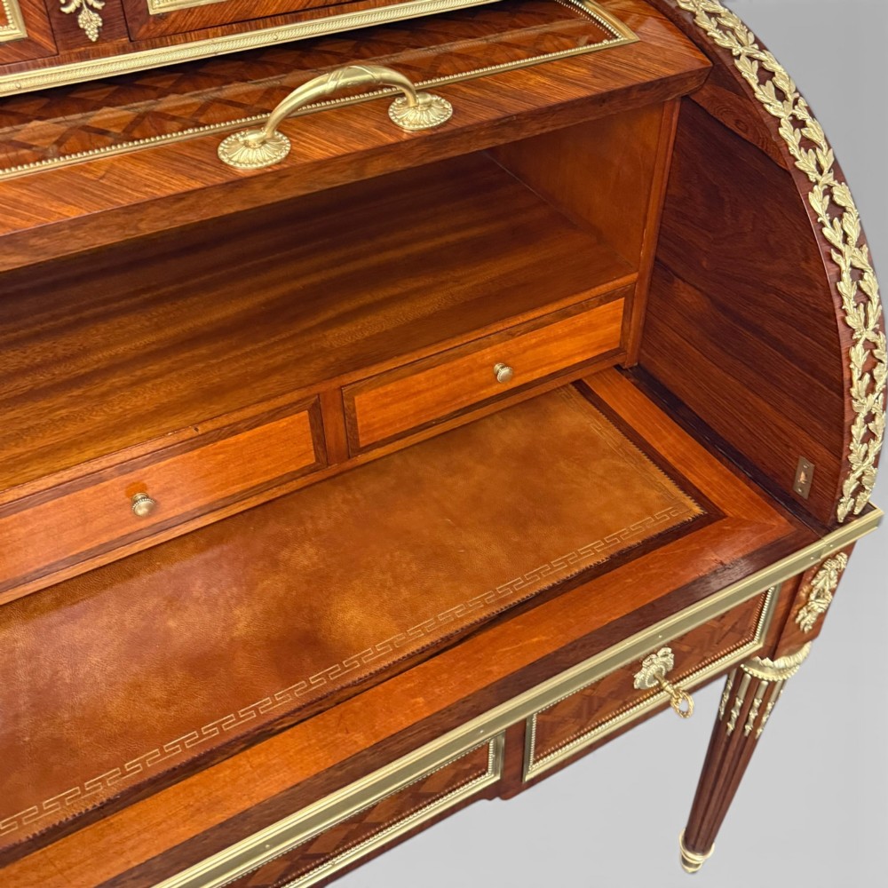 A French Louis XVI style cylinder desk featuring detailed geometric diamond parquetry, gilded bronze mounts, a top brass gallery rail, and slender fluted legs. View X