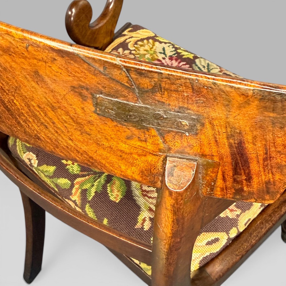 An antique William IV mahogany elbow armchair featuring scrolled armrests, turned front legs, and a floral tapestry upholstered seat. View XII
