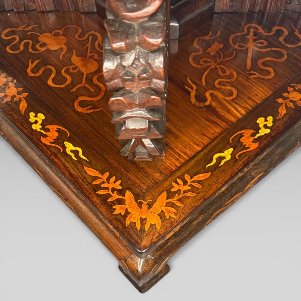 A circular dark rosewood centre table featuring detailed marquetry inlays depicting ships, pagodas, and flora. View IX