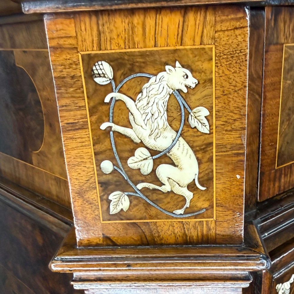 An Italian Baroque walnut commode featuring floral bone inlays across six drawer fronts, side panels, and top surface, supported by bracket feet. View XI