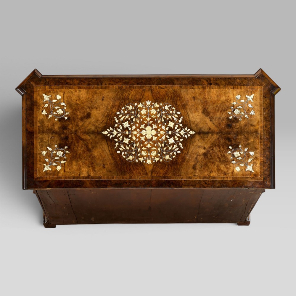 An Italian Baroque walnut commode featuring floral bone inlays across six drawer fronts, side panels, and top surface, supported by bracket feet. View XII