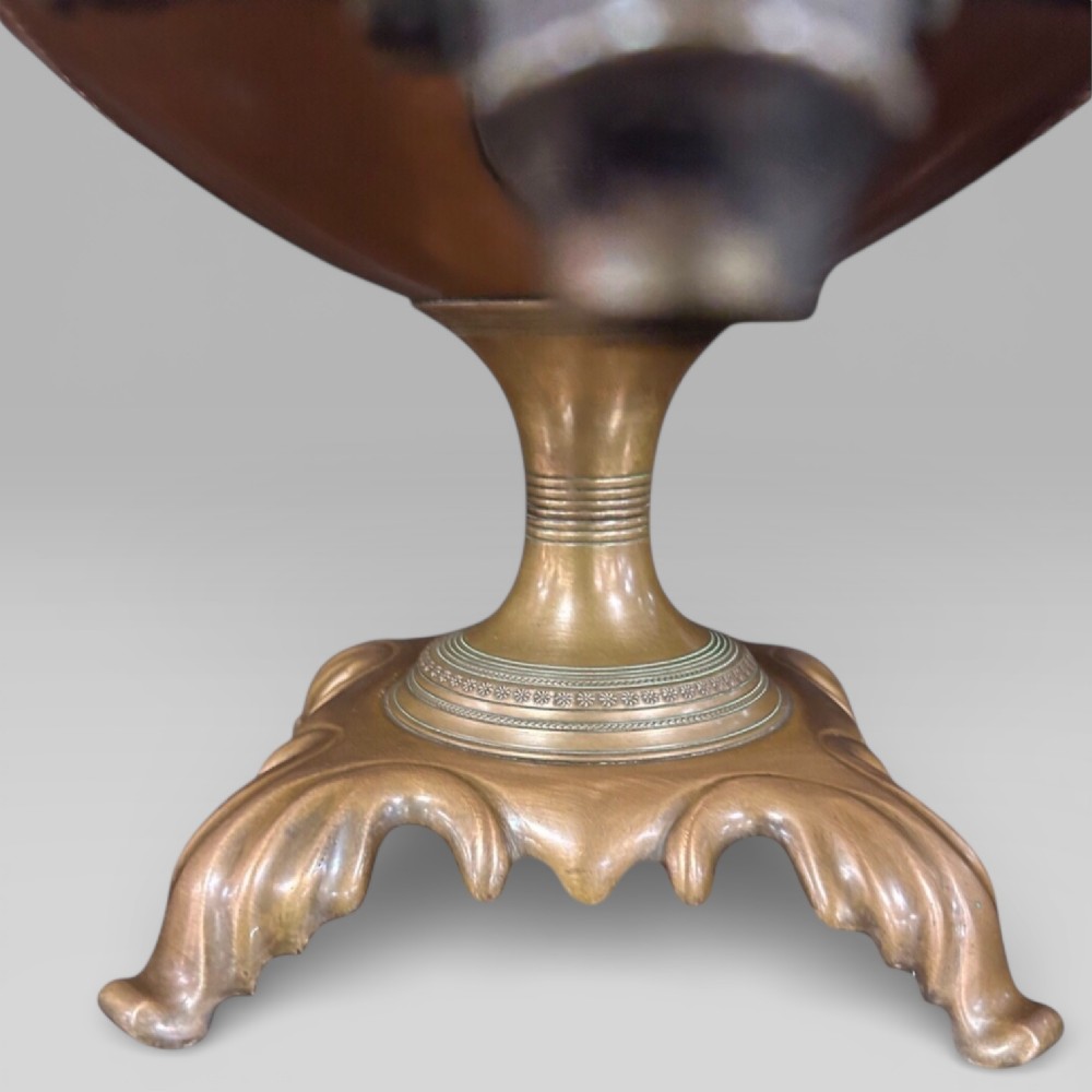 Top-down view of an antique Victorian copper samovar showing a crimped outer rim and a central heating pipe surrounded by a perforated metal interior. View VIII