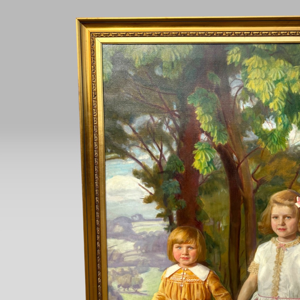 A full-length 1920s oil painting depicting two young children in a landscape setting, housed within a gilded wooden frame. View III