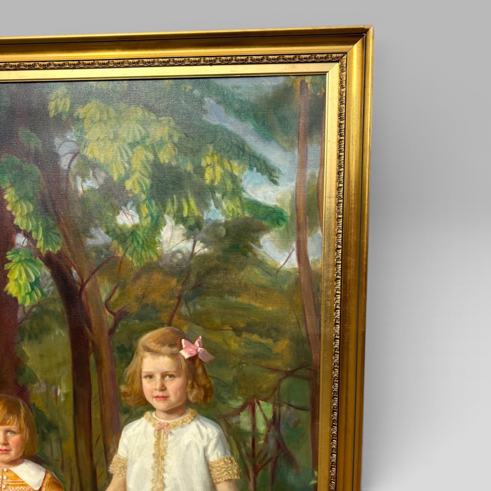 A full-length 1920s oil painting depicting two young children in a landscape setting, housed within a gilded wooden frame. View IV