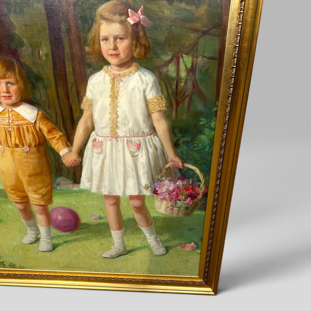 A full-length 1920s oil painting depicting two young children in a landscape setting, housed within a gilded wooden frame. View VI
