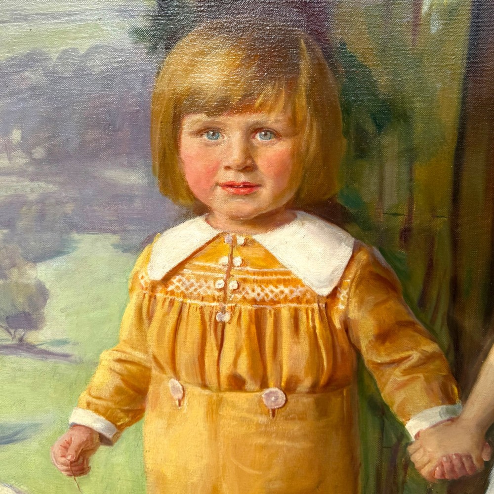 A full-length 1920s oil painting depicting two young children in a landscape setting, housed within a gilded wooden frame. View IX
