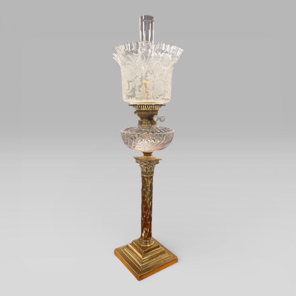 An antique Victorian oil lamp featuring a stepped brass column base, a cut glass reservoir, a duplex burner, and an etched glass tulip-shaped shade with a clear glass chimney. View II