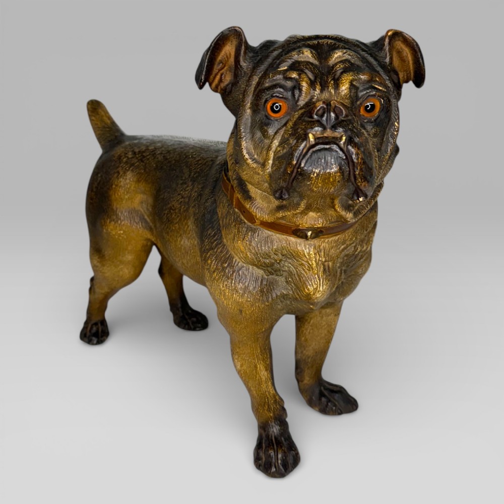A life-size antique Austrian terracotta sculpture of a standing pug dog with inset glass eyes and a moulded collar.