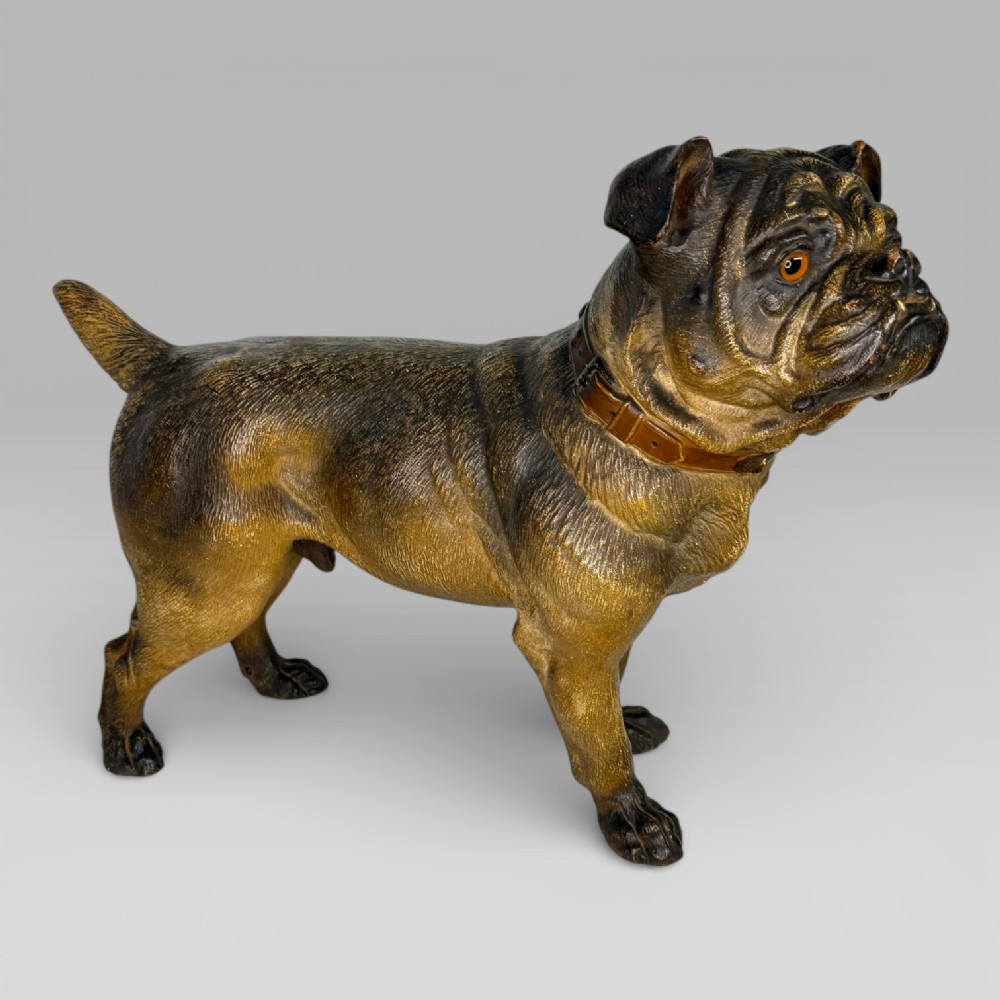 A life-size antique Austrian terracotta sculpture of a standing pug dog with inset glass eyes and a moulded collar. View II
