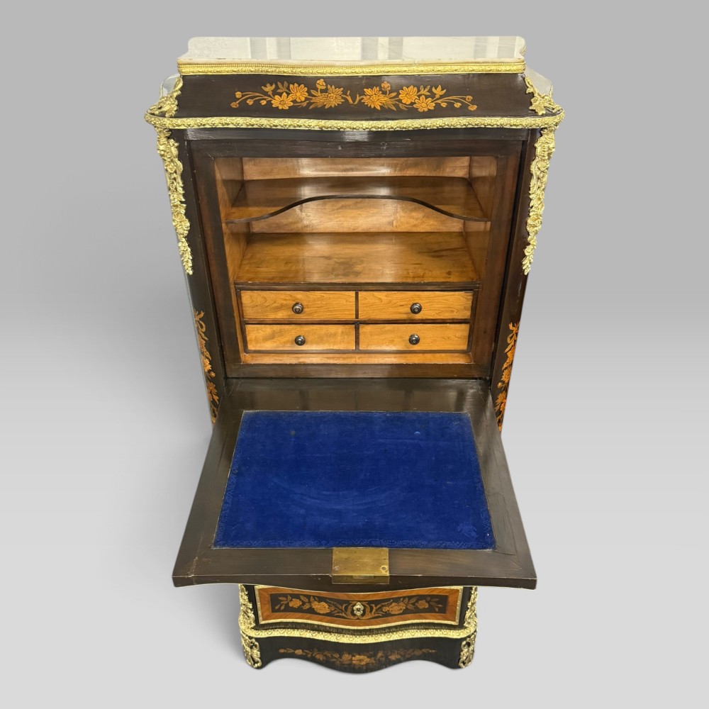 A pair of French Napoleon III narrow serpentine chests in kingwood and tulipwood featuring floral marquetry, gilt-bronze mounts, and marble tops. View VII