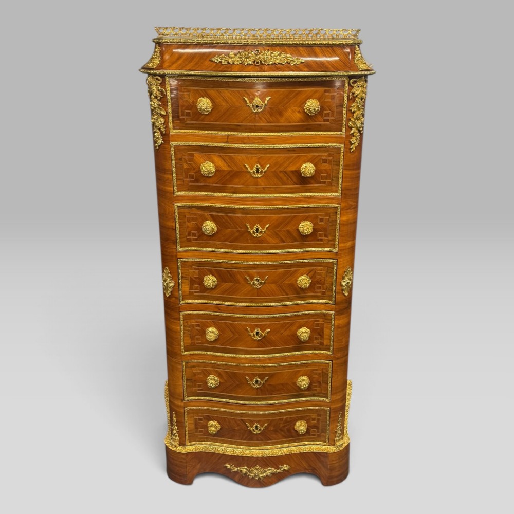 A tall antique French kingwood and rosewood secretaire chest featuring parquetry veneers, ornate gilt bronze mounts, seven drawer fronts, and a pierced brass gallery top. View II
