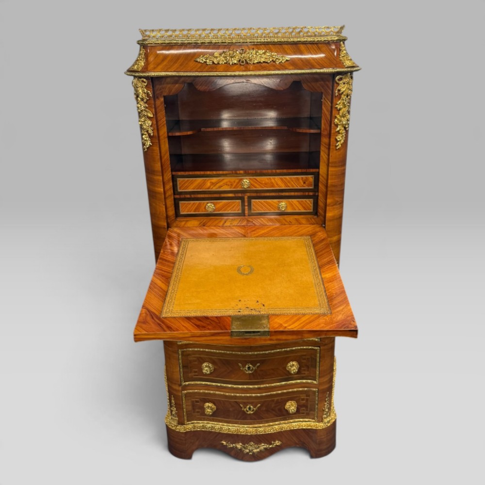 A tall antique French kingwood and rosewood secretaire chest featuring parquetry veneers, ornate gilt bronze mounts, seven drawer fronts, and a pierced brass gallery top. View III