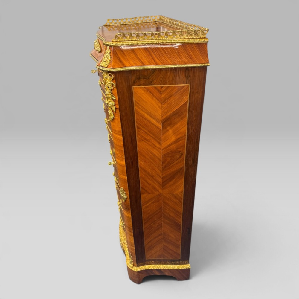 A tall antique French kingwood and rosewood secretaire chest featuring parquetry veneers, ornate gilt bronze mounts, seven drawer fronts, and a pierced brass gallery top. View V