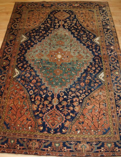 Antique Sarouk Rug with Abrashed Green Medallion, Circa 1900