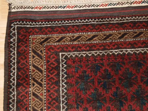 fig 1. ANTIQUE BALUCH RUG WITH LATTICE DESIGN, CAMEL BORDER, KILIM ENDS, CIRCA 1900.