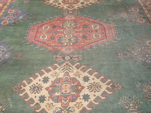 fig 1. ANTIQUE TURKISH OUSHAK CARPET, UNUSUAL GREEN FIELD WITH CAUCASIAN DESIGN, CIRCA 1900/20.