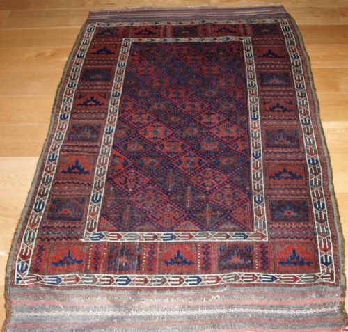 fig 1. VERY RARE ANTIQUE BALUCH RUG WITH CALYX LATTICE FIELD AND YOMUT TURKMEN BORDERS, 2ND HALF 19TH CENTURY.