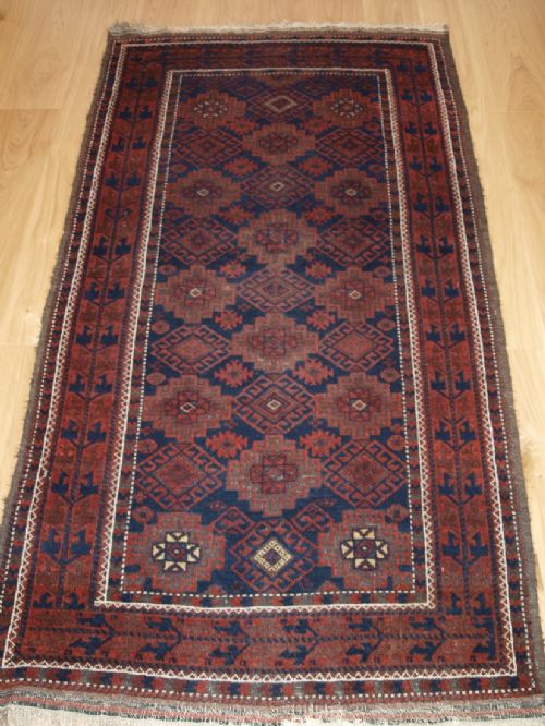 Antique Baluch Rug with Repeat Design, Heavy Corrosion, Circa 1900.
