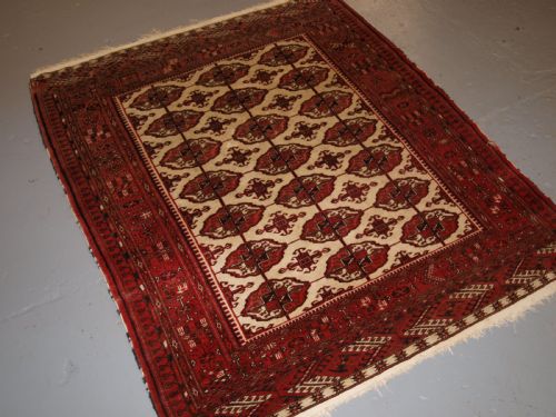 Old Afghan Turkmen Rug with Tekke Design on a Scarce Ivory Ground. Circa 1920.
