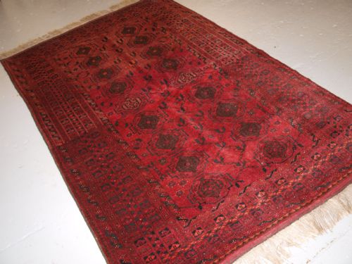 Old Afghan Village Rug with Turkmen Chuval Gul Design, Plum Red Colour, Circa 1920.