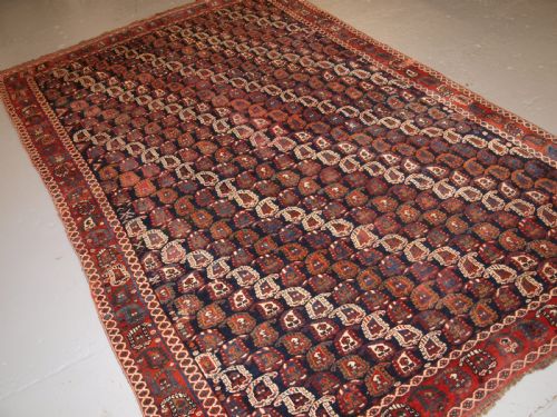 Antique Persian Rug by the Khamseh Tribe with All Over Boteh Design, Late 19th Century.