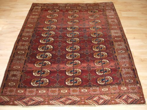 Antique Tekke Turkmen Rug with Abrashed Madder Red Field, Circa 1900.