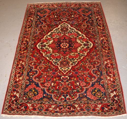 Antique Persian Bakhtiari Village Rug, Floral Medallion Design, Circa 1920.