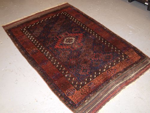 fig 1. ANTIQUE TIMURI BALUCH RUG OF SINGLE MEDALLION DESIGN, CIRCA 1880.