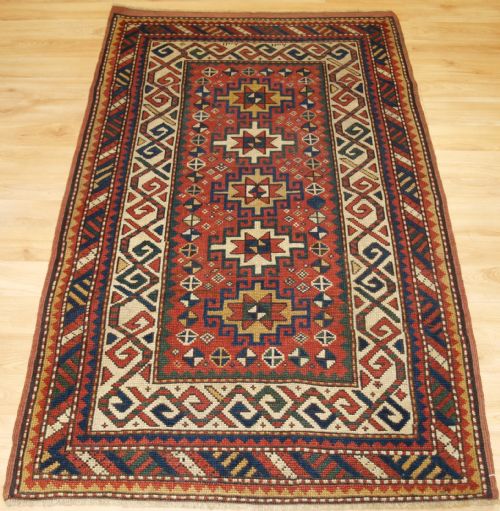 Antique Caucasian Kazak Rug with Memlinc Guls, Small Size, Circa 1900.