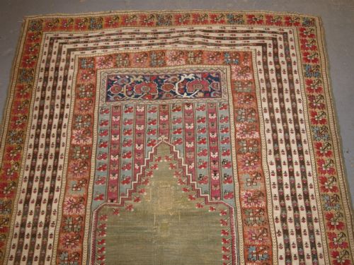 fig 1. ANTIQUE TURKISH GHIORDES PRAYER RUG, MULTIPLE BORDERS, GREEN FIELD, CIRCA 1800.