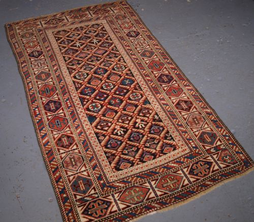 fig 1. ANTIQUE CAUCASIAN DAGESTAN RUG, LATTICE DESIGN WITH HUMAN FIGURES, CIRCA 1880.
