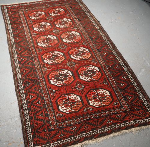 fig 1. ANTIQUE MAHDAD KHANI BALUCH RUG, LARGE TURKMEN GULS, CIRCA 1900.