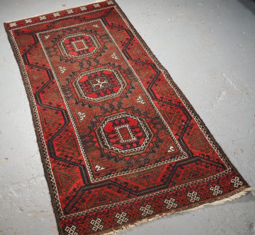 fig 1. ANTIQUE SALAR KHANI BALUCH RUG, TURRETED GUL DESIGN, CIRCA 1900.