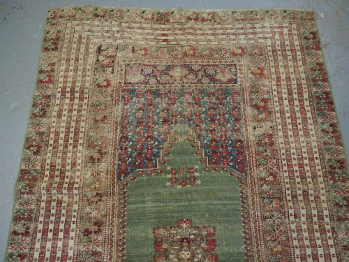 fig 2. ANTIQUE TURKISH GHIORDES PRAYER RUG, MULTIPLE BORDERS, GREEN FIELD, CIRCA 1750.