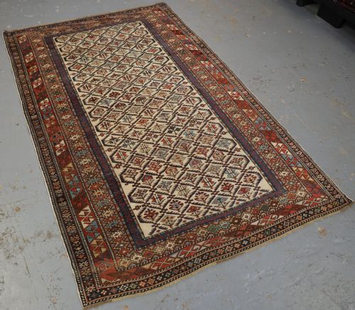 fig 1. ANTIQUE CAUCASIAN DAGESTAN RUG WITH IVORY GROUND FLORAL LATTICE, SUPERB, CIRCA 1880.