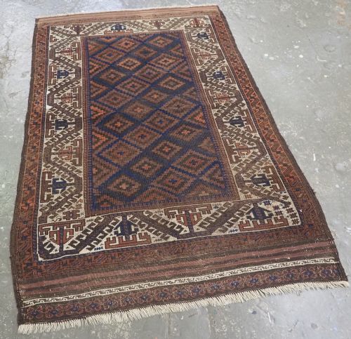 fig 1. ANTIQUE TIMURI OR BALUCH RUG, LARGE IVORY BORDER, CIRCA 1880.