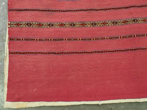 fig 2. An antique rectangular Tekke Turkmen Kizil chuval woven textile with detailed horizontal geometric bands across a magenta red wool field.