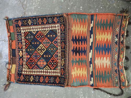 fig 1. An antique 19th-century Jaf Kurd woven bag featuring a knotted pile upper panel with geometric diamond lattice motifs and a colourful flatweave back section.