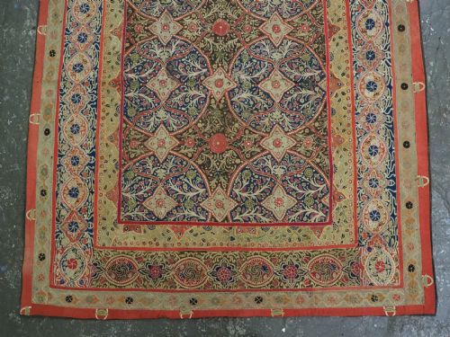 fig 3. A rectangular 19th-century Persian Rasht textile featuring elaborate floral and geometric lattice patterns crafted from silk embroidery and felt applique in red, blue, green, and cream tones.