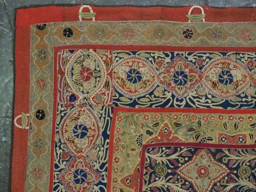 fig 4. A rectangular 19th-century Persian Rasht textile featuring elaborate floral and geometric lattice patterns crafted from silk embroidery and felt applique in red, blue, green, and cream tones.