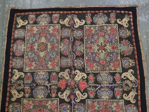 fig 3. An antique Persian Rasht textile featuring silk floral and boteh embroidery on a black wool felt ground.